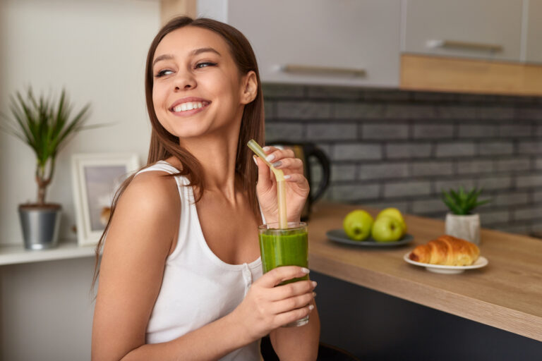 woman drinking green smoothie